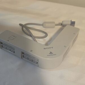 Sony PlayStation Multitap Accessory in Light Gray and White